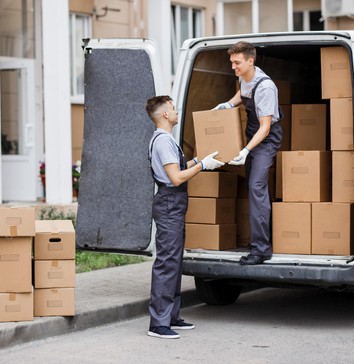 Reliable moving crew loading boxes into van at home location – Easy Best Moves