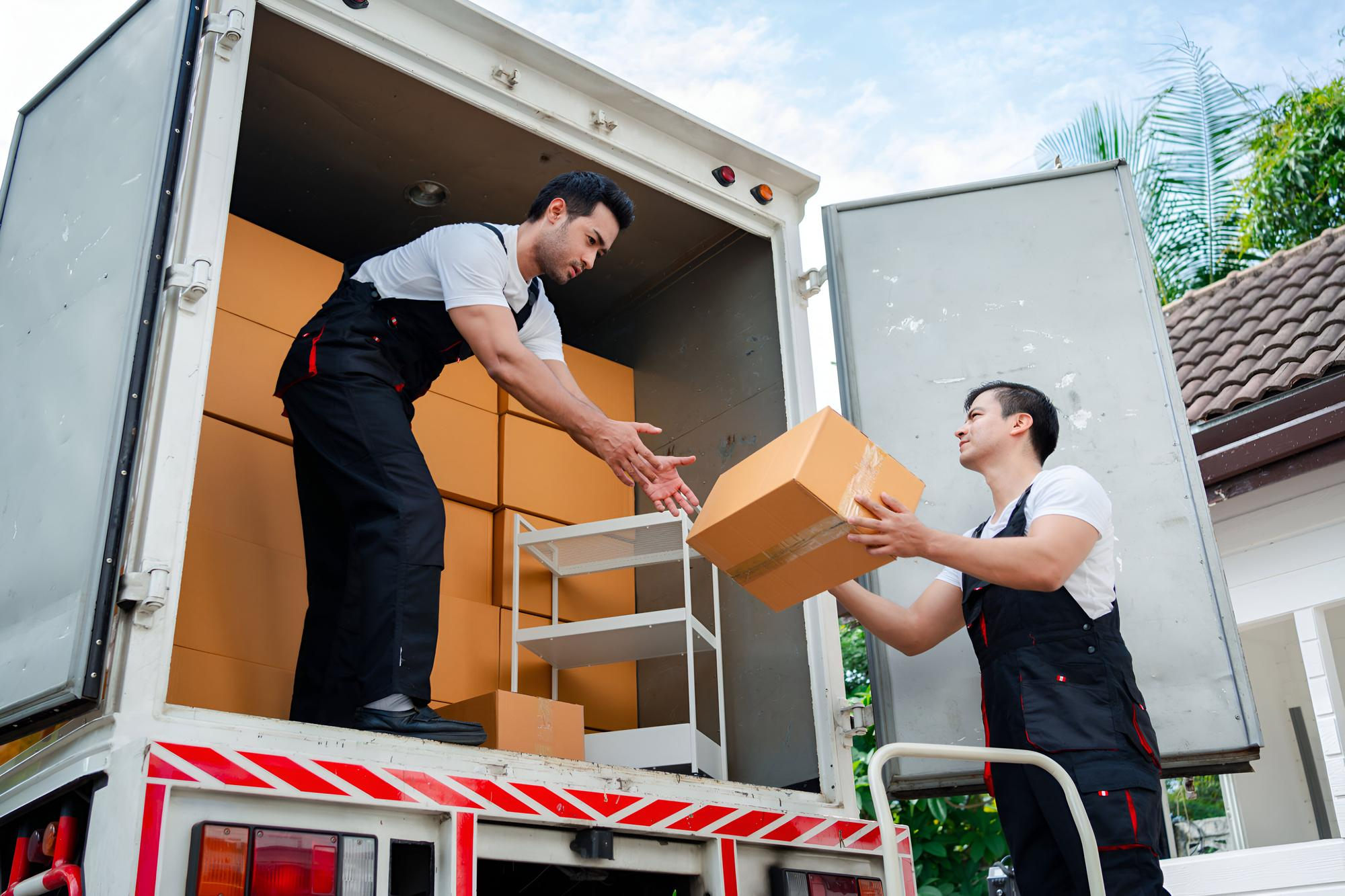 Local movers carefully loading a moving truck with furniture and boxes – Easy Best Move