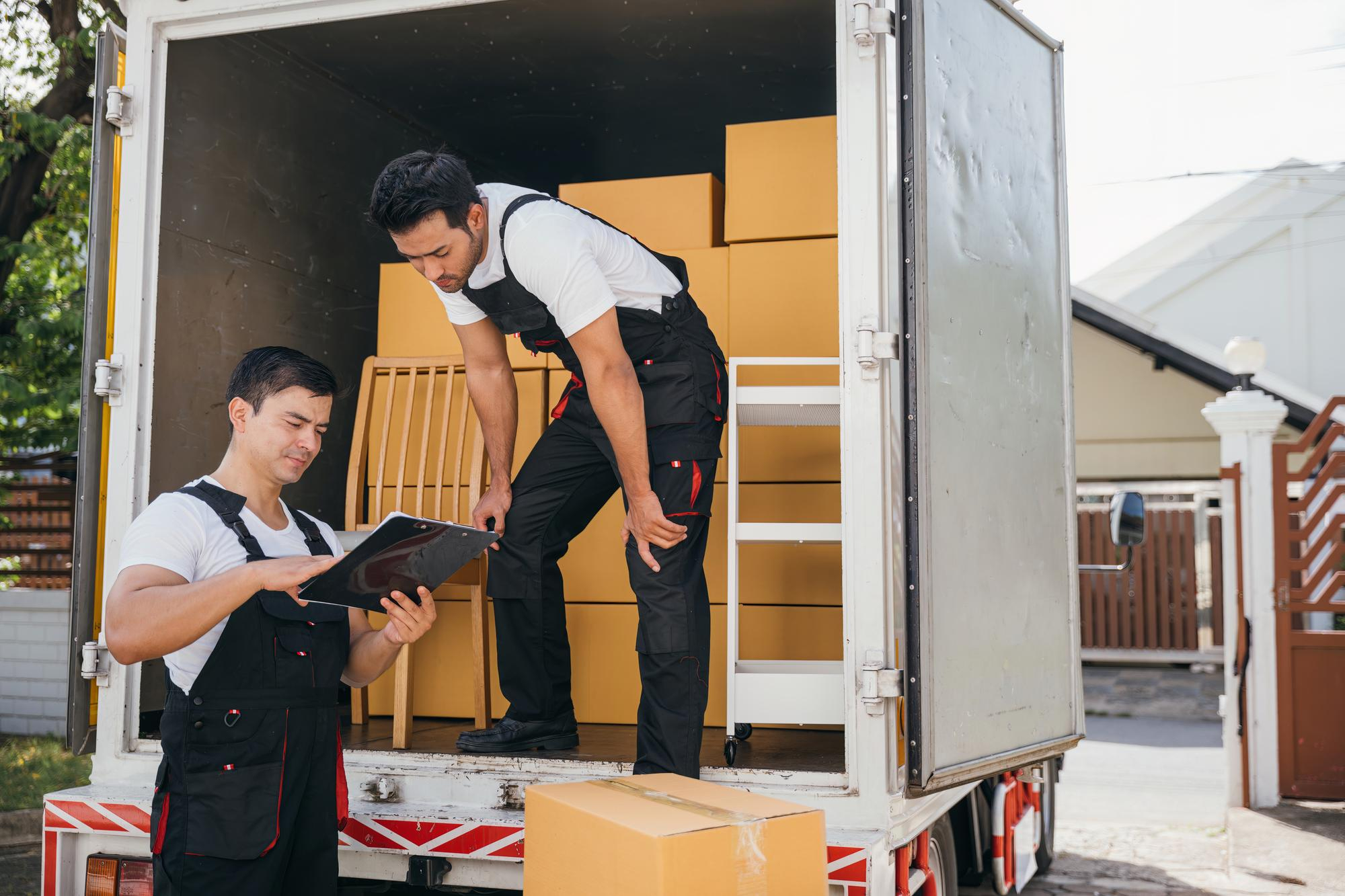 Local movers unloading furniture and boxes from a moving truck – Easy Best Move